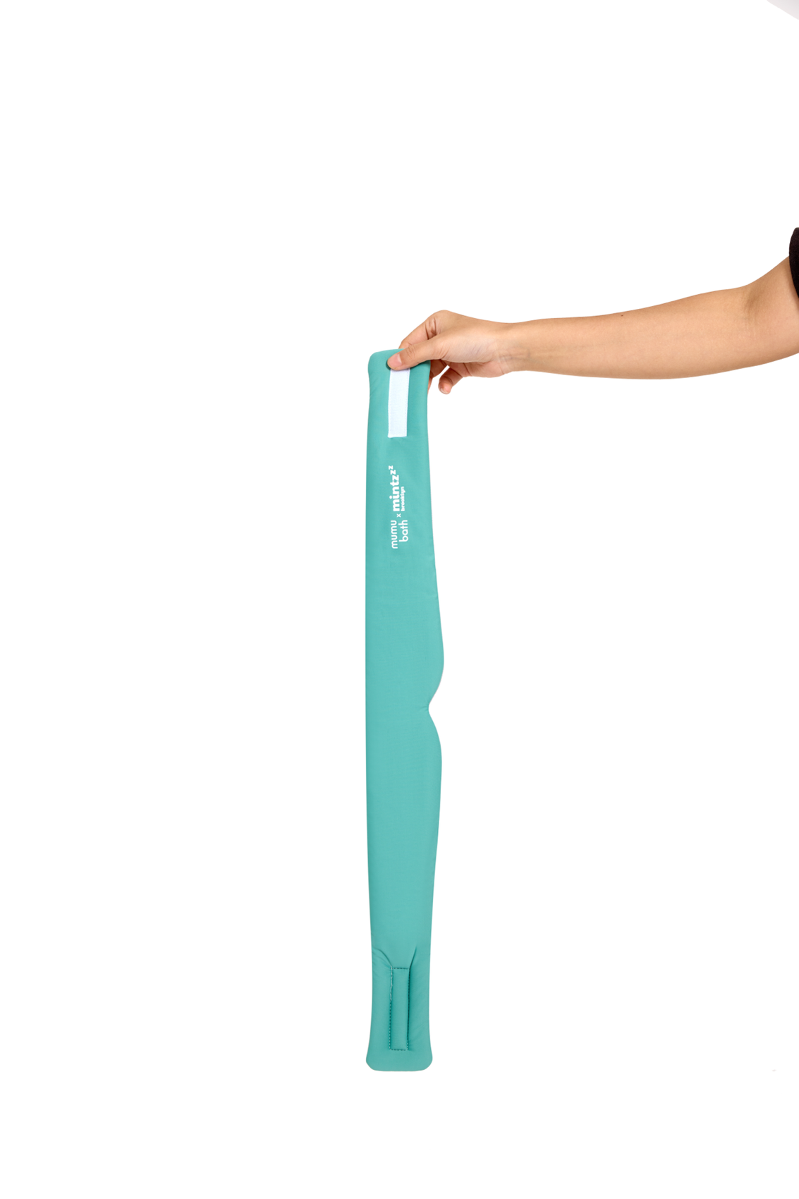 A hand holds the Mintzzz Chill Mask | Cooling Sleep Mask—long, turquoise, and padded—vertically against a white background.
